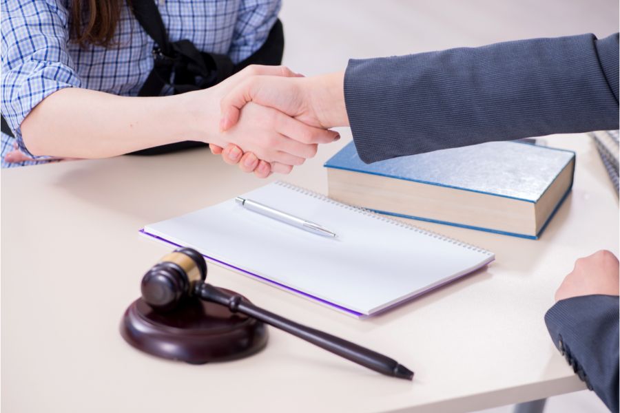 car accident lawyer shaking hands with client